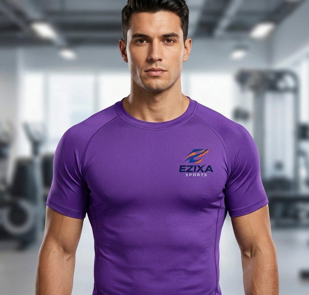 Front view of athletic male model wearing purple short sleeve EZIXA Sports compression shirt in gym.